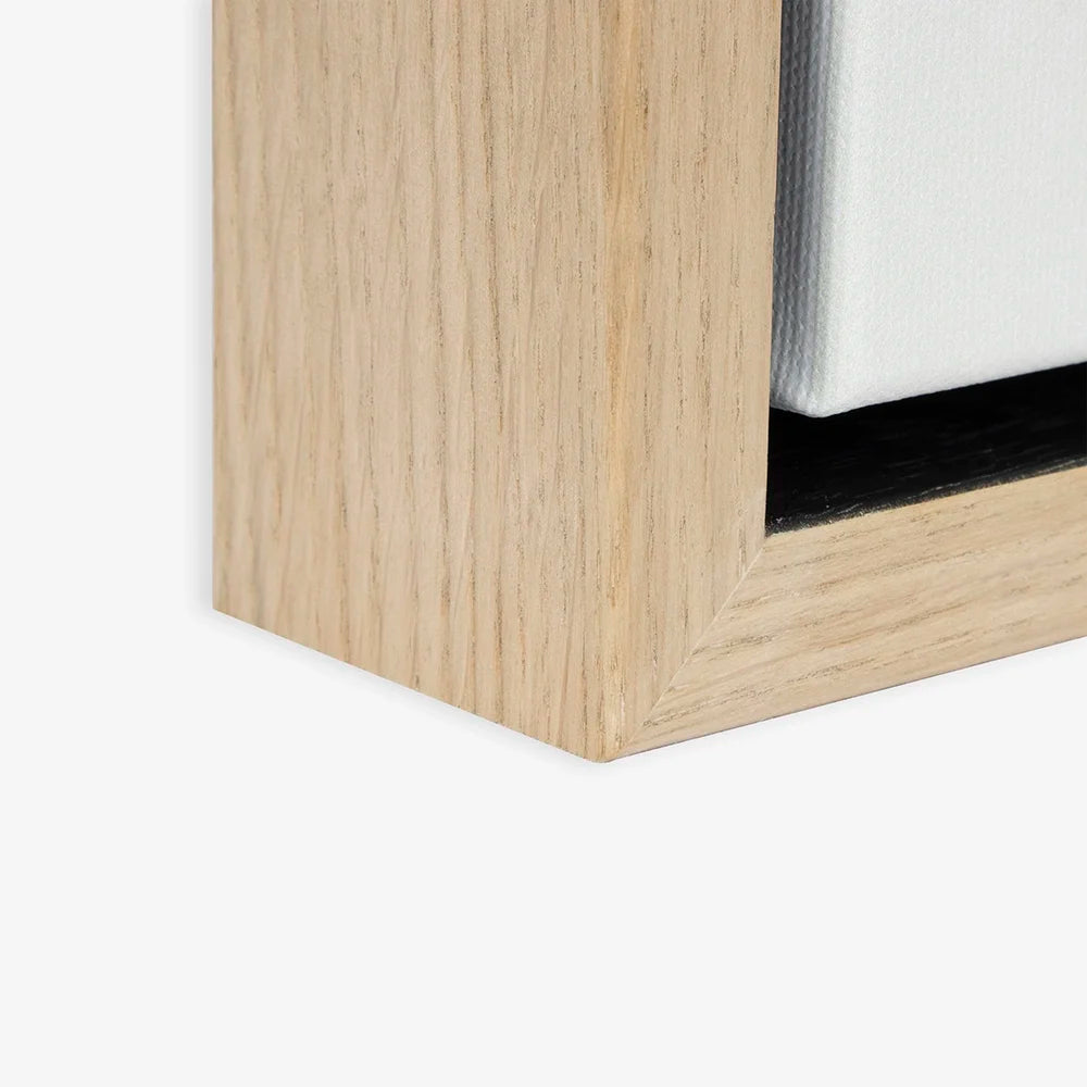 Close-up of the natural wood floating frame and gap around the canvas.